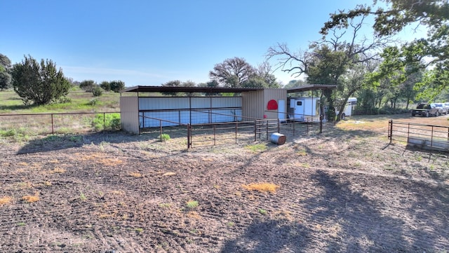 view of front of property with a rural view and an outdoor structure