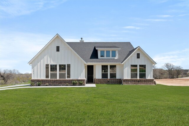 modern inspired farmhouse with central AC and a front lawn