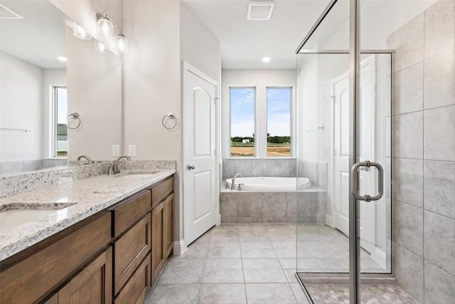 bathroom with tile patterned flooring, vanity, and separate shower and tub