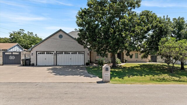 view of front of home with a garage and a front yard