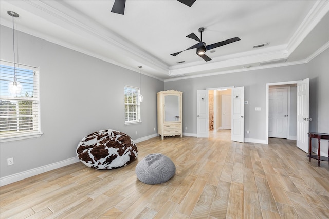 sitting room with light hardwood / wood-style floors, ornamental molding, ceiling fan, and a raised ceiling