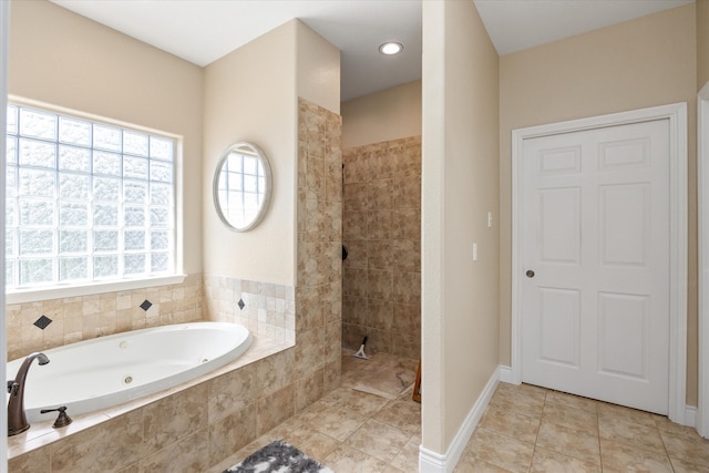 bathroom with separate shower and tub and tile patterned flooring