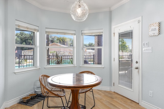 dining room with light hardwood / wood-style flooring and ornamental molding