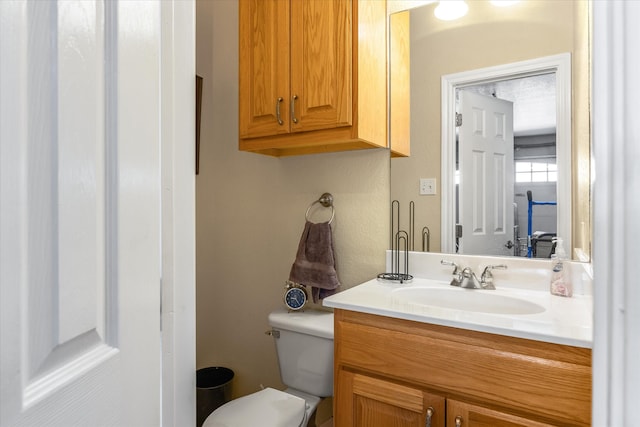 bathroom featuring toilet and vanity