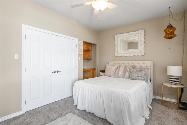 carpeted bedroom with ceiling fan and a closet