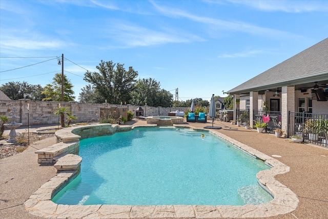 view of pool featuring a patio and an in ground hot tub