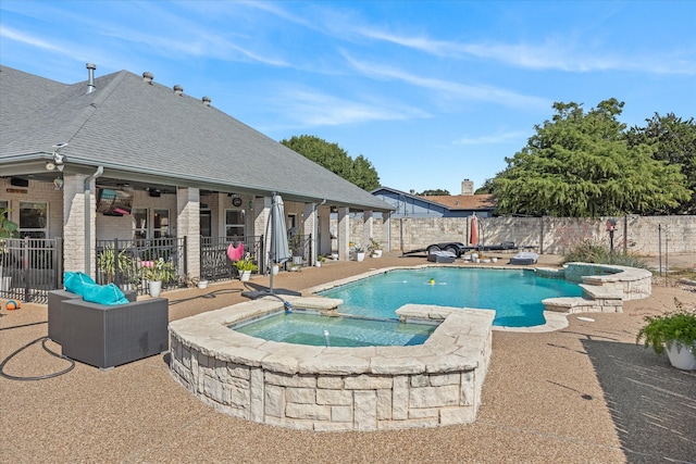 view of pool with an in ground hot tub and a patio area