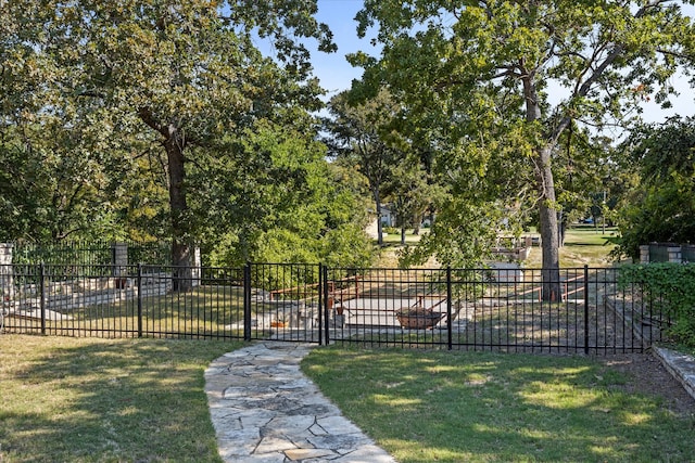 view of gate featuring a yard