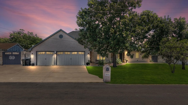 view of front facade featuring a lawn and a garage