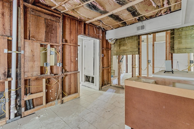 basement featuring wood walls