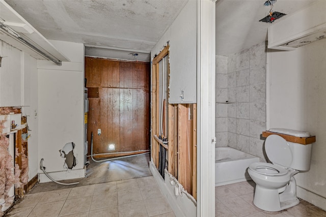 bathroom featuring a textured ceiling, toilet, and tile patterned flooring