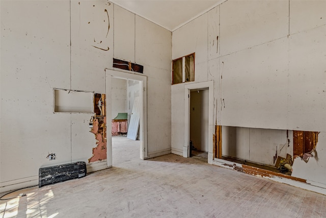 unfurnished living room with high vaulted ceiling