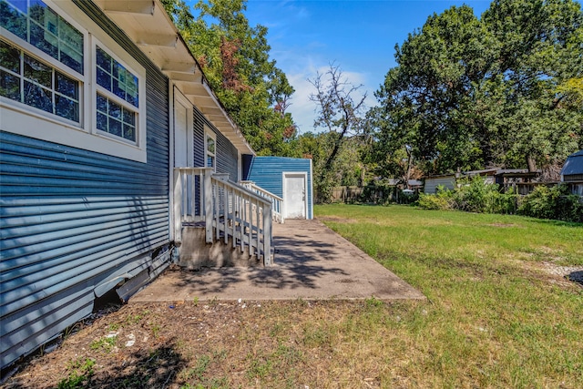 view of yard with an outbuilding and a patio