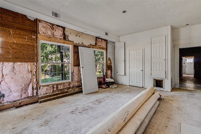 interior space with a fireplace and a textured ceiling