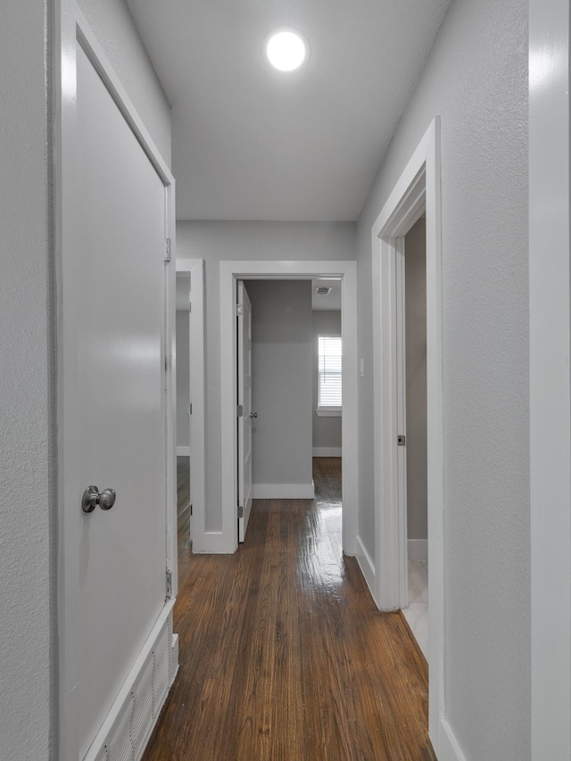 hall with dark hardwood / wood-style flooring