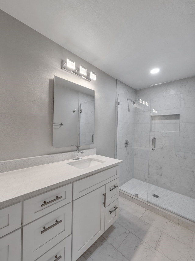 bathroom featuring vanity and a shower with door