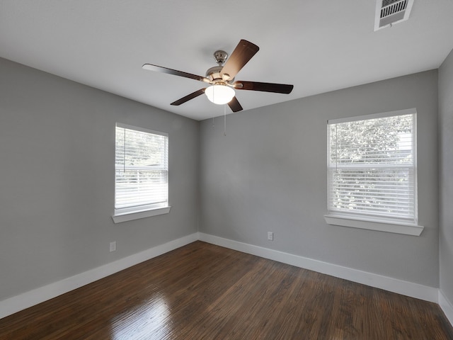 empty room with dark hardwood / wood-style floors and ceiling fan