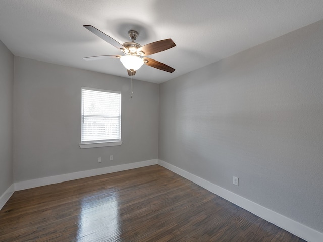 spare room with ceiling fan and dark hardwood / wood-style flooring