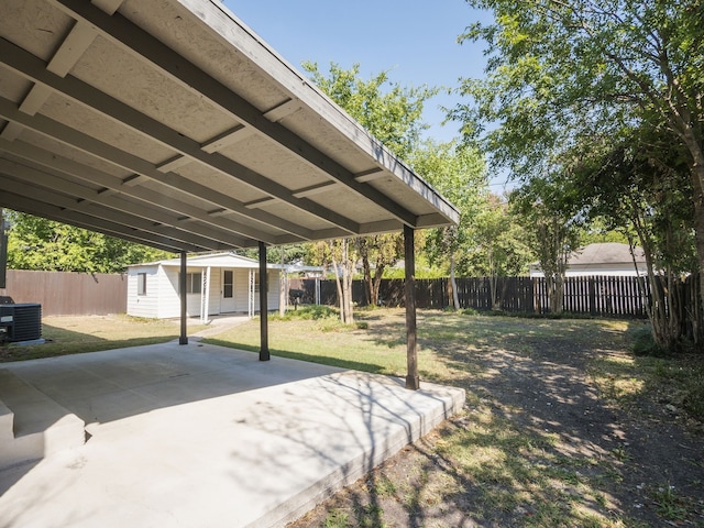 view of community featuring a yard, an outbuilding, and a patio area