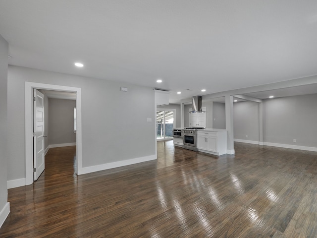 unfurnished living room with dark wood-type flooring