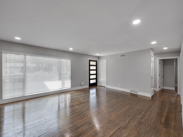 unfurnished room featuring dark hardwood / wood-style flooring