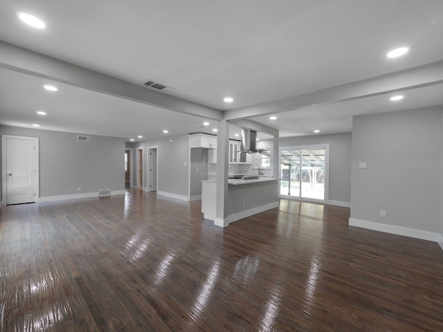 unfurnished living room with dark wood-type flooring