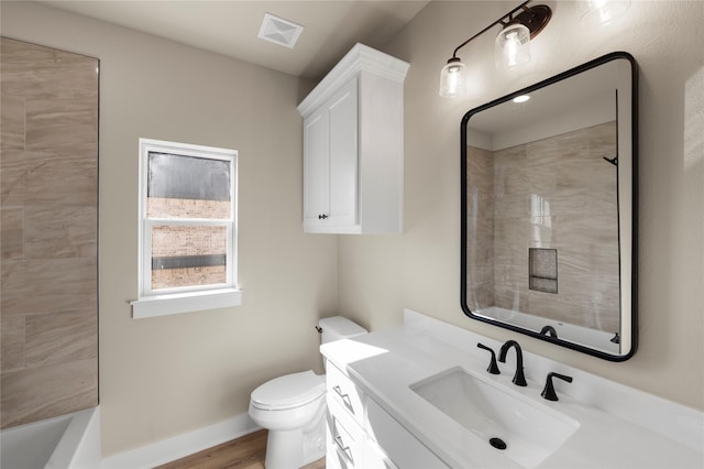 full bathroom with tiled shower / bath, vanity, toilet, and wood-type flooring