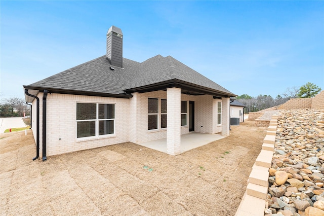 rear view of house featuring central AC unit and a patio