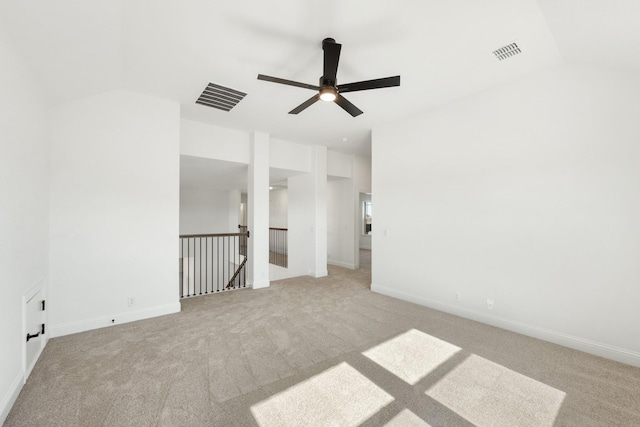 carpeted empty room with vaulted ceiling and ceiling fan