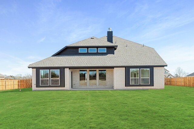 rear view of property featuring a yard