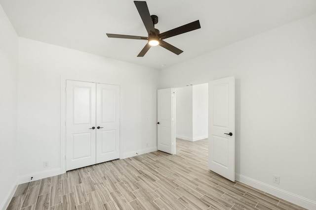 unfurnished bedroom featuring light wood-type flooring, ceiling fan, and a closet