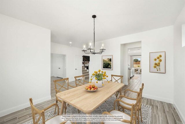 unfurnished dining area featuring an inviting chandelier and light hardwood / wood-style floors