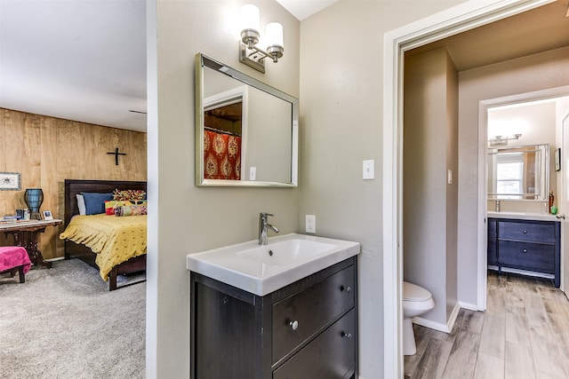 bathroom featuring vanity, hardwood / wood-style flooring, and toilet