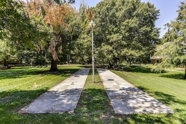 view of property's community with a lawn