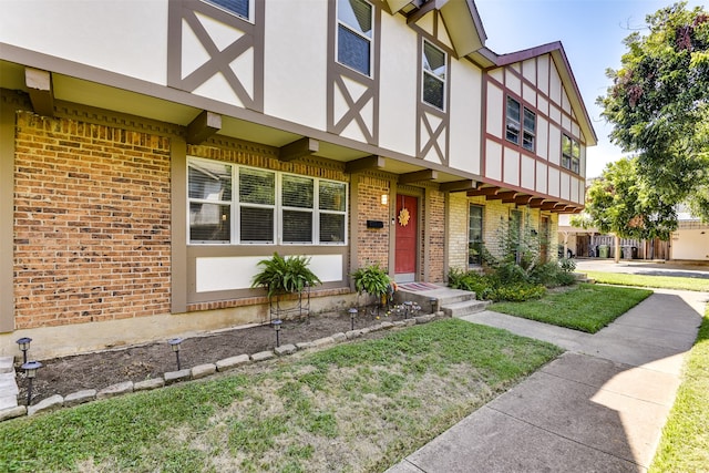 view of front of property featuring stucco siding and brick siding