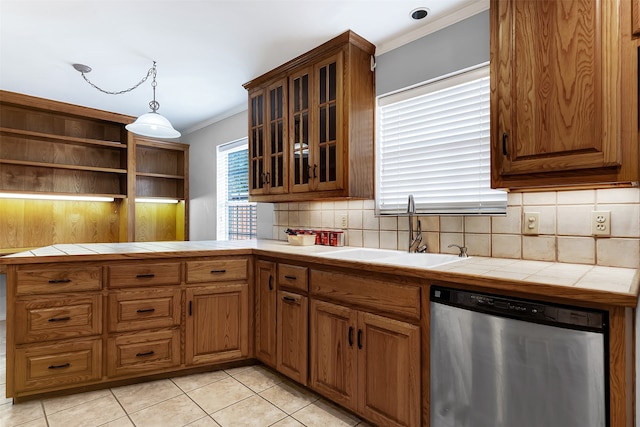 kitchen with dishwasher, tile counters, light tile patterned floors, and sink