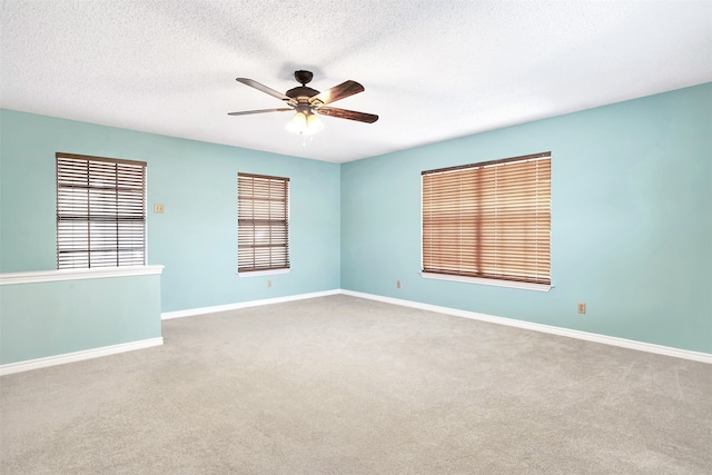 unfurnished room with light carpet, ceiling fan, and a textured ceiling