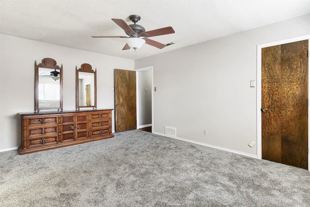 unfurnished bedroom featuring a textured ceiling, carpet flooring, and ceiling fan