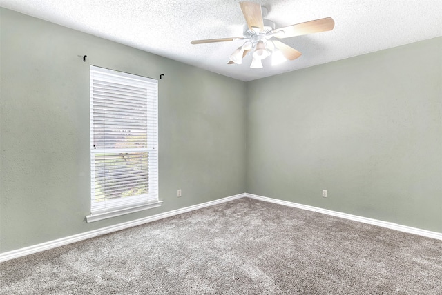 carpeted spare room featuring ceiling fan and a textured ceiling