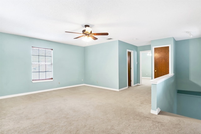 unfurnished room featuring light carpet and ceiling fan