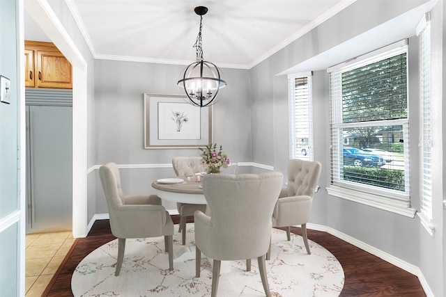 dining space featuring crown molding, hardwood / wood-style floors, and a notable chandelier