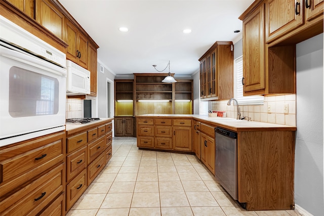 kitchen featuring light tile patterned flooring, tasteful backsplash, sink, hanging light fixtures, and stainless steel appliances