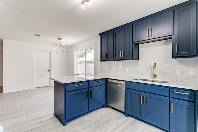 kitchen featuring dishwasher, an inviting chandelier, tasteful backsplash, sink, and kitchen peninsula