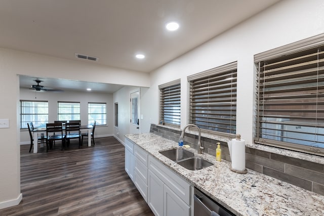 kitchen with dark hardwood / wood-style flooring, ceiling fan, white cabinetry, light stone countertops, and sink