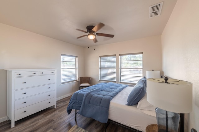 bedroom with ceiling fan and dark hardwood / wood-style floors