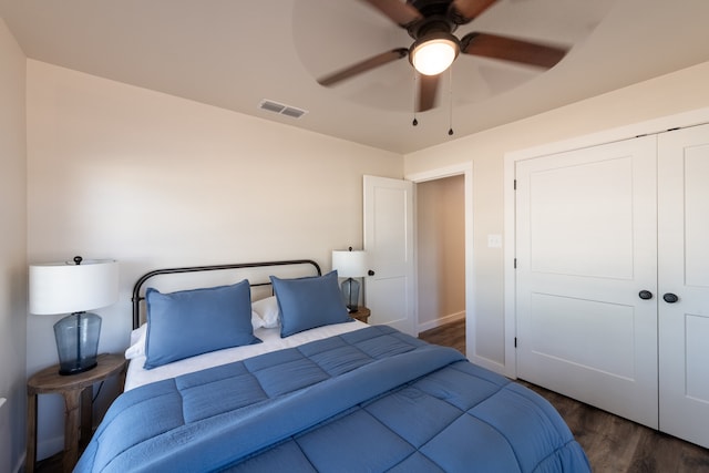 bedroom with ceiling fan, dark hardwood / wood-style floors, and a closet