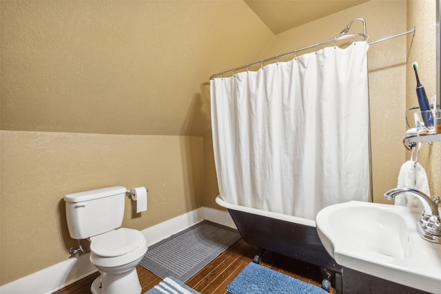 full bathroom featuring toilet, shower / bathtub combination with curtain, sink, vaulted ceiling, and hardwood / wood-style floors