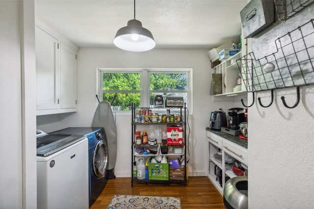 washroom featuring cabinets, dark wood-type flooring, and independent washer and dryer