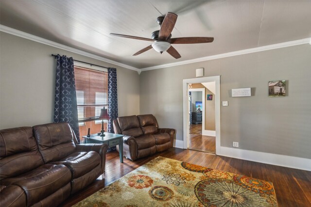 living room with crown molding, dark wood-type flooring, and ceiling fan