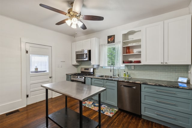 kitchen featuring tasteful backsplash, stainless steel appliances, white cabinetry, sink, and dark hardwood / wood-style floors